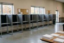 Empty voting booths set up in a community center room ahead of voters arriving