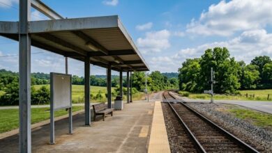 A commuter rail platform beside a single track in rolling Middle Tennessee countryside