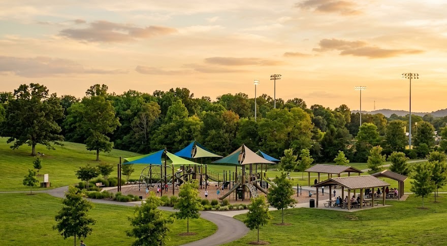 A community park playground with shade trees (illustrative)