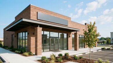 A newly built suburban retail storefront with blank signage and fresh landscaping (illustrative)