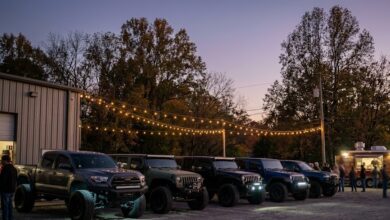 Lifted trucks and Jeeps at an evening off-road show and shine (illustrative AI-generated image)